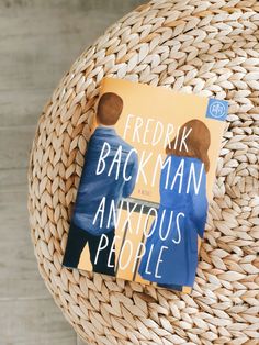 a book sitting on top of a wicker chair