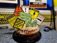 a cake that has been decorated with various road signs on it and is sitting on top of a table