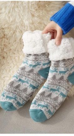 Walking in the Winter Wonderland or even just on your cold floors in the winter; these knitted slipper socks will keep your feet nice and cozy on those cold winter days and nights. Featuring a with faux fur lining and a rubber sole design on the bottom to prevent slipping when walking these are sure to be a new favorite part of your lounge wear. Made with a polyester and cotton blend. Comes in 21 fun patterns from which to choose. Slipper Design, Halloween Wigs, Halloween Sweater, Soft Sock, Fits Women, Winter Socks, Knitted Slippers, Halloween Festival, Round Neck Sweaters