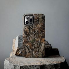 an iphone case sitting on top of a rock