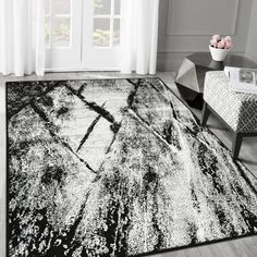 a black and white rug in a living room