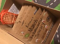 an open cardboard box with some stickers on it and a tennis racquet