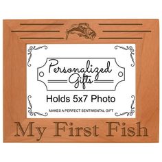 a wooden frame with the words, my first fish on it and an image of a fish