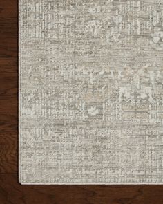 an area rug with wood flooring in the background