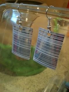 two tags are hanging from the side of a clear container