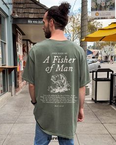 This Unisex garment-dyed t-shirt features "Jesus Made Me | A Fisher of Man | Mark 1:16-18" with a vintage fish illustration on the back and "I Catch & He Cleans" on the front. Spread hope and the gospel with this Christian tee <3 » A B O U T « ‣ This item is made to order using direct-to-garment (DTG) printing technology. This digital process involves the printer inks being jetted or sprayed onto the textile by a print head after the garment goes through a pre-treatment machine to create a stron Christian Mens Shirts, Mens Christian Apparel, Fishing T Shirts Design, Cool Christian Tshirts, Christian Graphic Tees Men, Men’s Graphic Tee, Men’s Tshirts, Shirt Print Design Graphic Tees, Mens Christian Shirts