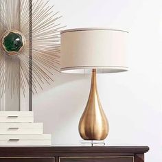 a table lamp sitting on top of a wooden dresser