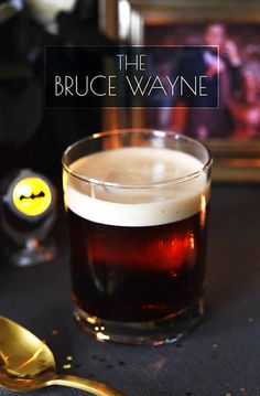 a close up of a glass of beer with a yellow smiley face in the background