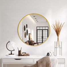 a white desk topped with a mirror next to a chair