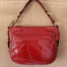 New Vintage Coach Patent Leather Red "Zoe" Bag. 100% Authentic. Amazing Color That Will Make Your Jaw Drop In A Classic And Sophisticated Style!! Features Zip Top Opening, Great Chunky Bronze Hardware, Large Satin-Like Tan Interior Lining With Plenty Of Pockets And Space. Size Is 12 (W) X 9.5(H) X 3.5(D). New, Never Used, No Tags, Comes With Dust Bag And Care Instructions. Comes From Smoke Free Home. Red Hobo Bag With Detachable Strap For Evening, Red Coach Satchel, Red Coach Shoulder Bag With Detachable Handle, Red Rectangular Hobo Bag For Evening, Rectangular Red Hobo Bag For Evening, Modern Red Shoulder Bag With Gold-tone Hardware, Modern Red Crossbody Hobo Bag, Modern Red Bags With Gold-tone Hardware, Luxury Red Tote Bag