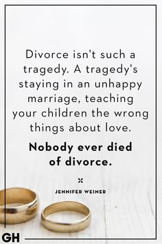 two gold wedding rings sitting next to each other on top of a white table with a quote about marriage