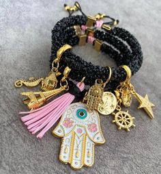 Add a touch of bohemian flair to your look with this stunning bracelet featuring 7 strands, each adorned with unique charms, including protective Evil Eyes or Hamsa hand, all suspended from a glittering cord. Handcrafted with care in Colombia, this adjustable bracelet combines elegance with meaningful symbolism, making it a truly special piece of boho jewelry. Designed for those who love to layer, this bracelet serves as a perfect blend of fashion and spirituality. The shimmering cord enhances t Bohemian Charm Bracelet As Gift, Bohemian Charm Bracelet With 8mm Beads As Gift, Handmade Bohemian Charm Bracelet, Bohemian Stackable Charm Bracelet, Bohemian Multicolor Charm Bracelet, Handmade Jewelry Set, Layering Bracelets, Lucky Charm Bracelet, Unique Handbag