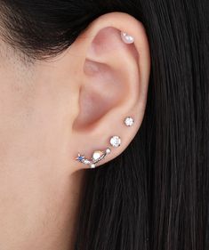 a close up of a person wearing ear piercings