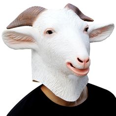 a man wearing a goat mask on top of his head and tongue sticking out to the side