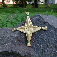 a wooden cross sitting on top of a rock