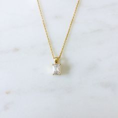 This is a dainty necklace with a small emerald cut CZ pendant. Perfect for everyday wear. Necklace Metal: 24K Gold filled Necklace Size: 16 in Pendant Metal : 18K Gold FilledPendant Size: 13 mm x 5 mm Pendant Stone: Cubic Zirconia Yellow Gold Baguette Cut Cubic Zirconia Necklace, Gold Necklaces With Rectangular Stone For Formal Occasions, Gold Baguette Cut Solitaire Necklace, Elegant Yellow Gold Necklaces With Rectangular Stone, Gold Diamond Jewelry With Rectangular Stone, Timeless Gold Necklace With Emerald Cut, Elegant Baguette Cut Solitaire Necklace For Gift, Luxury Baguette Cut Solitaire Necklace As Gift, Gold Cubic Zirconia Rectangular Pendant Jewelry