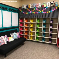 a room filled with lots of toys and bookshelves next to a black couch