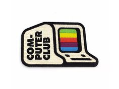 a white patch with the words,'computer club'in black and rainbow colors