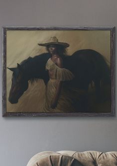 a woman standing next to a horse in front of a painting hanging on the wall