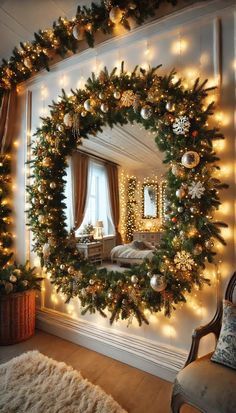 a christmas wreath hanging on the wall next to a mirror with lights and garlands around it