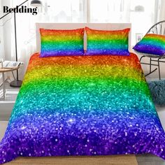 a bed with a rainbow colored comforter and pillows