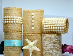 three rolls of burlap with pearls and a starfish