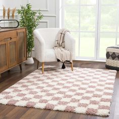 a living room area with a chair and rug