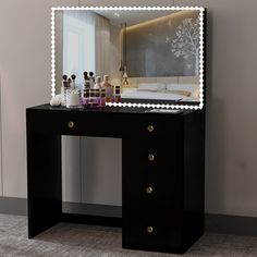 a vanity table with a lighted mirror on it