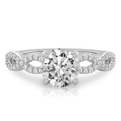 a white gold engagement ring with an oval cut diamond surrounded by round brilliant pave diamonds