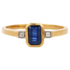 Blue Sapphire ring in 18K Gold which perfectly goes with your personality and also helps you to learning and spiritual healing. Designed with Blue Sapphire in center and diamonds at sides that makes it a perfect fit to wear it on your wedding or style it with any of your basic outfit to give it a glam. PRODUCT DETAILS :- > Material - 18K Solid Yellow Gold > Gemstone - Blue Sapphire > Gemstone Weight - 0.67 ct > Stone Shape - Octagon > Stone Size - 6*4 mm > Diamond Weight - 0.02 ct > Gross Weight - 2.978 Grm > Shank width - 1.6 mm > Setting - Bezel setting We can customize the Gold Gemstone Ring according to your specification. Go to our Storefront Page for more updates and click on the follow button to never miss out on our newly added jewelry collection. All our jewelry products are stamp Luxury Gold Sapphire Ring With Polished Finish, Luxury Gold Sapphire Ring In Modern Style, Luxury Everyday Yellow Gold Sapphire Ring, Yellow Gold Sapphire Baguette Cut Ring With Accent Stones, Yellow Gold Emerald-cut Sapphire Diamond Ring, Emerald Cut Sapphire Diamond Ring In Yellow Gold, 14k Gold Blue Rings With Single Cut Diamonds, Yellow Gold Emerald-cut Sapphire Ring With Accent Stones, Yellow Gold Cocktail Ring