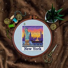 the statue of liberty in new york cross - stitch pattern is displayed on a brown blanket