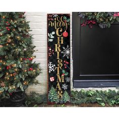 a christmas door hanger with the words merry on it in front of a house