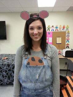 a girl with mouse ears on her head and overalls