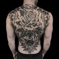 a man with tattoos on his back and chest