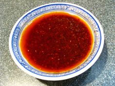 a blue and white bowl filled with red sauce