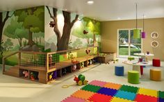 a child's playroom with colorful flooring and wall murals on the walls