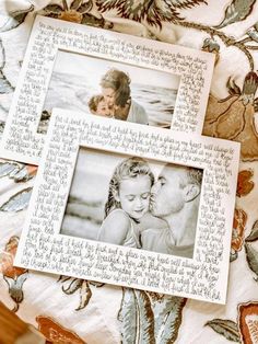 an old photo frame sitting on top of a bed next to a flowered blanket