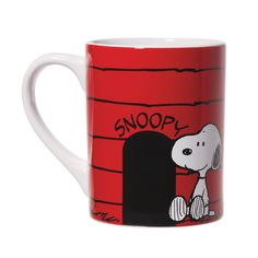 a red coffee mug with a snoopy cartoon on it