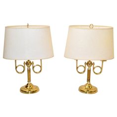 pair of brass table lamps with white shades