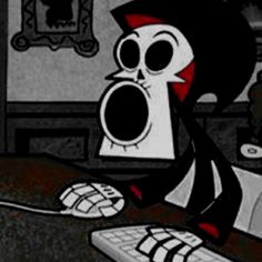 a cartoon character sitting in front of a computer keyboard