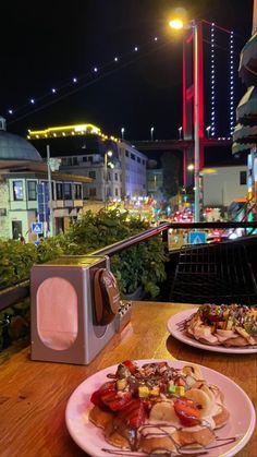 two plates of food sitting on top of a table next to a toaster oven