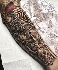 a man's arm with an egyptian tattoo on it