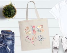 "Vintage Wildflowers Tote Bag, Floral Tote Bag, Shoulder Bag, Wildflower Tote Bag, Mothers Day Gift, Garden Bag, Plant Women Tote Bag Welcome to ComfortTeeStore  Great to see you here. In ourstore, you can find your dream style. 📌Product Description 100% Cotton Material. Standard Size Bag Standard Length (21\") Self-fabric handles Reinforces at stress points for extra durability 📌 Product Size  Measurements -> 15\"W x 16\"H Tolerance -> +/- 1 📌Care Instructions * Wash item inside out in cold Everyday Spring Canvas Gift Bag, Spring Canvas Gift Bag, Eco-friendly Canvas Bag For Spring Gift, Botanical Bags For Everyday Use In Summer, Eco-friendly Bags For Spring Gifts, White Botanical Style Bag For Spring, Eco-friendly Floral Print Spring Bags, Eco-friendly Flower Shaped Bags For Spring, Eco-friendly Spring Gift Bags