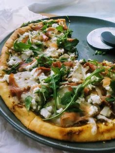 a pizza sitting on top of a pan covered in toppings