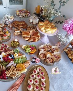 a table filled with lots of food and desserts