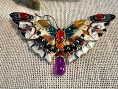 Brooch Outstanding Sterling vintage Enameled Butterfly with bezel set Carnelian and Tigereye with an Amethyst drop.  Condition is very good, safety catch works, pictures show the details.  Size approx. 2 2/3" by 1 1/2", wt.-  9.2 grams.  One of the nicest vintage enameled sterling Butterfly pins I've seen.  Butterflies symbol for transformation, lightness and JOY! Multicolor Brooch Jewelry As Gift, Unique Collectible Jewelry Brooch, Multicolor Jewelry Brooch As Gift, Unique Gemstone Brooches For Jewelry Making, Multicolor Brooch Jewelry For Gift, Unique Cabochon Brooches As Gift, Elegant Handmade Enamel Pin, Unique Multicolor Jewelry With Brooch, Multicolor Jeweled Enamel Jewelry