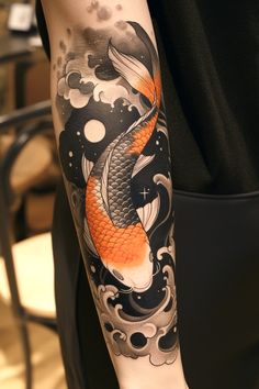 a man's arm with a koi fish and clouds tattoo design on it