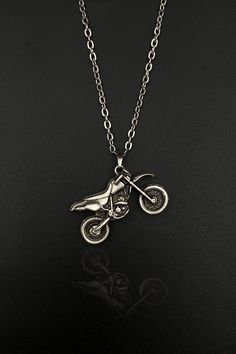 Welcome to an exclusive listing of our Cross Motorcycle necklace, a unique piece of moto jewelry that is a perfect blend of style and passion for all motorcycle enthusiasts. This captivating necklace is not only a symbol of your love for biking but also a fashionable accessory that makes a statement. Handcrafted with precision and care, this biker necklace is a symbol of freedom, adventure, and the open road. In a world of mass-produced jewelry, stand out with our handcrafted Cross Motorcycle ne Cross Motorcycle, Symbol Of Freedom, Tiny Necklace, Motorcycle Men, Biker Gifts, Moto Cross, Iphone 2, Gothic Necklace, Hippie Necklace