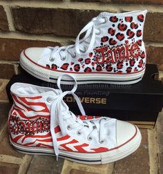 Zebra and Leopard Print Chuck Taylor Hi Tops hand painted in school colors personalized with your students name and appropriate color bling.  A client of mine saw my Handpainted Diva Converse Hi Top Shoe design here https://www.etsy.com/listing/482182751/custom-pink-converse-custom-converse?ref=shop_home_active_40 and loved them and wanted some for her niece and wanted some in her school colors of Boomer Red and White. I added matching bling and here we go, School Spirit Shoes! You can get them Mj Homecoming, Spirit Overalls, Personalized Converse, Homecoming 2022, Shoe Painting, Painted Converse, Color Converse, Painting Shoes, Converse Hi