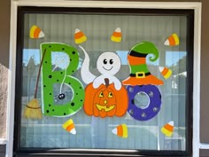 a window decorated with halloween decorations and the letter b is for boos, jack - o'- lanterns, and pumpkins